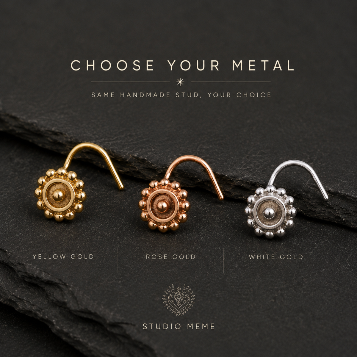 three different colored metal studs, each with a unique design, arranged on a dark background.