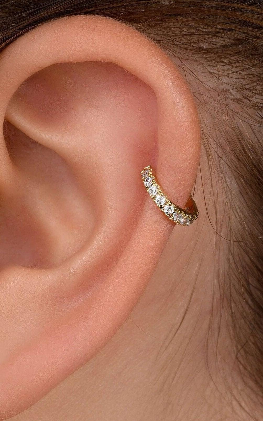 Cartilage Hoop Earring: A gold-colored earring with small diamonds set in it is shown in the image.