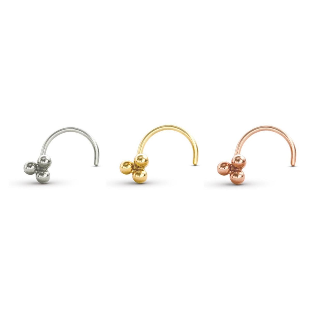 three different colored metal nose rings, each with a unique design and color.