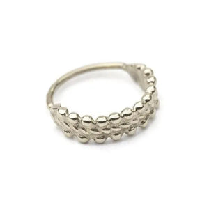 A silver-colored ring with a textured, bead-like design.