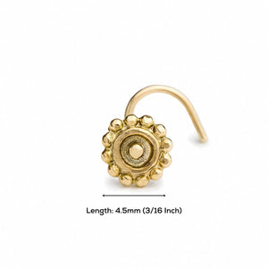 A gold-colored nose ring with a decorative design, accompanied by a measurement scale indicating its length.