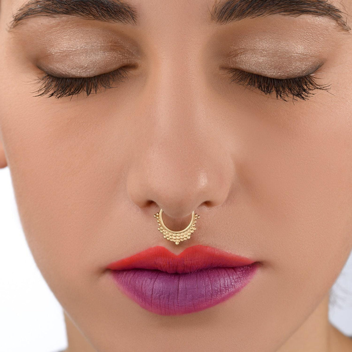 A close-up of a woman's face, focusing on her lips and nose with her eyes closed.