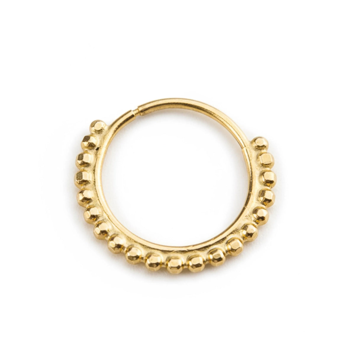 A gold-colored metal ring with a decorative pattern of small, round beads or stones along the outer edge.