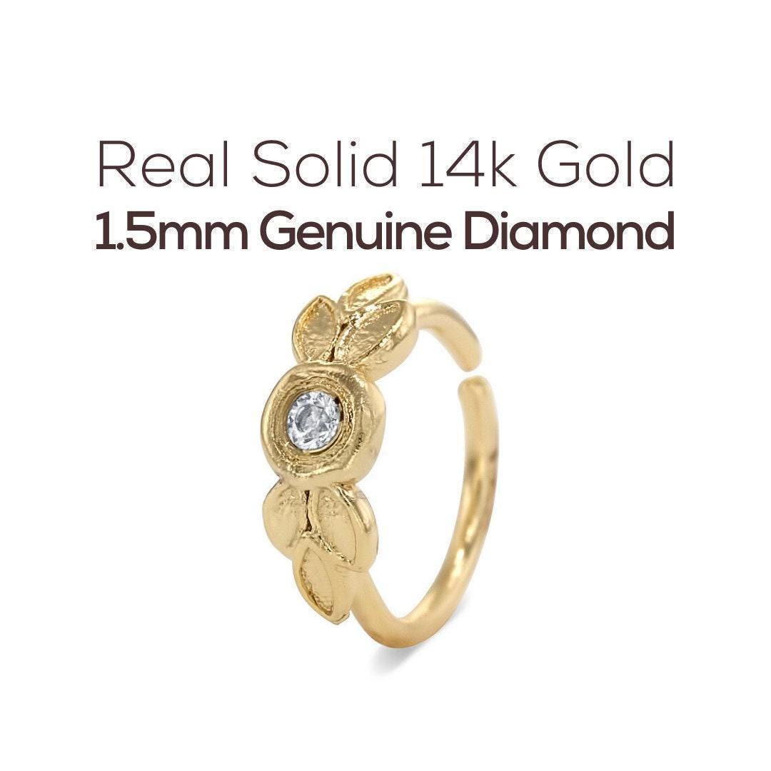 a gold ring with a genuine diamond set in the center.