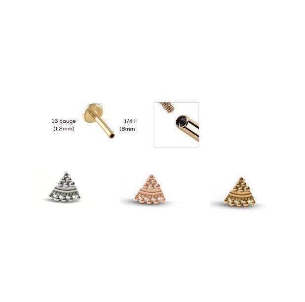 three different types of jewelry, including a gold-colored earring, a silver-colored earring, and a gold-colored earring with a unique design.
