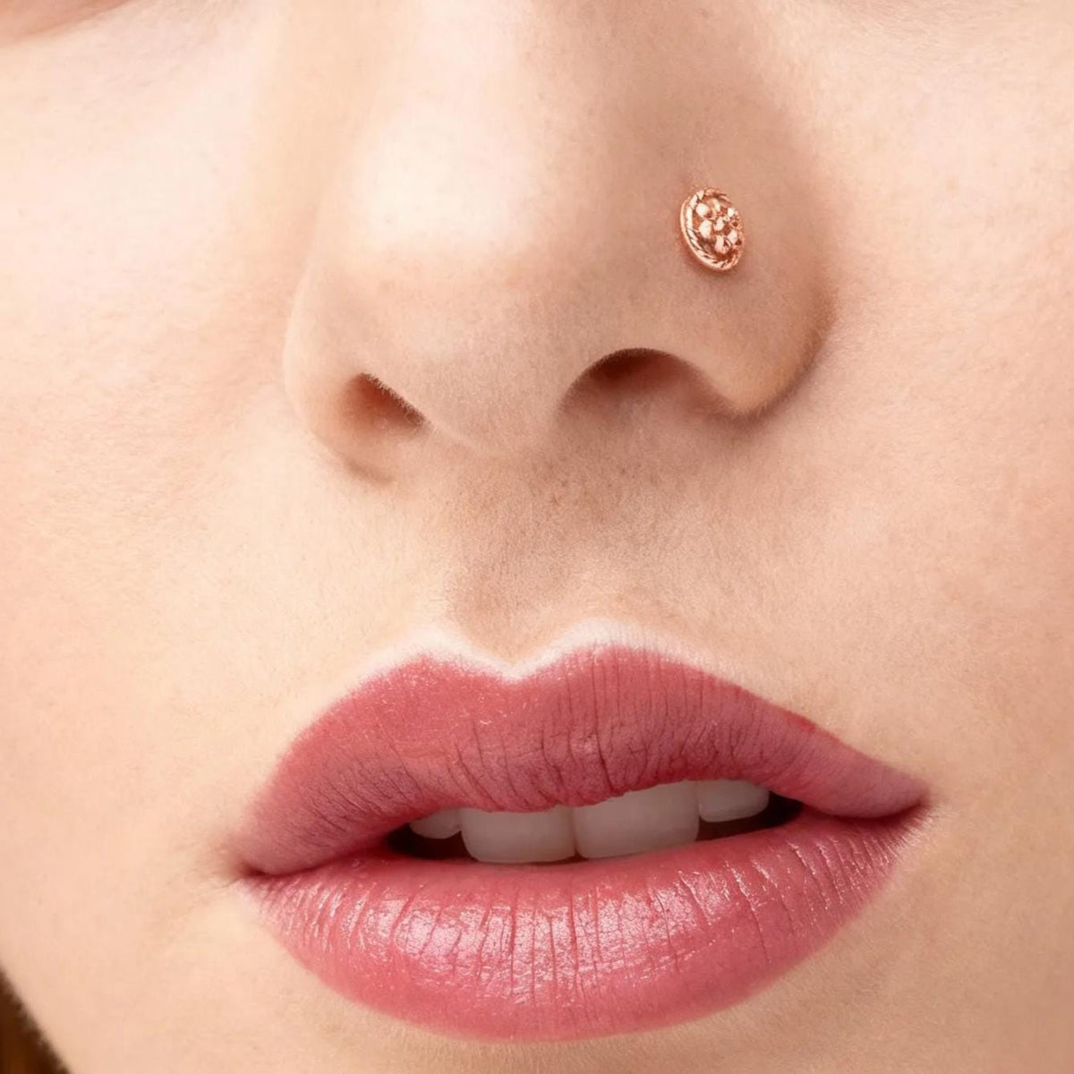 A close-up of a woman's face, focusing on her nose and lips.