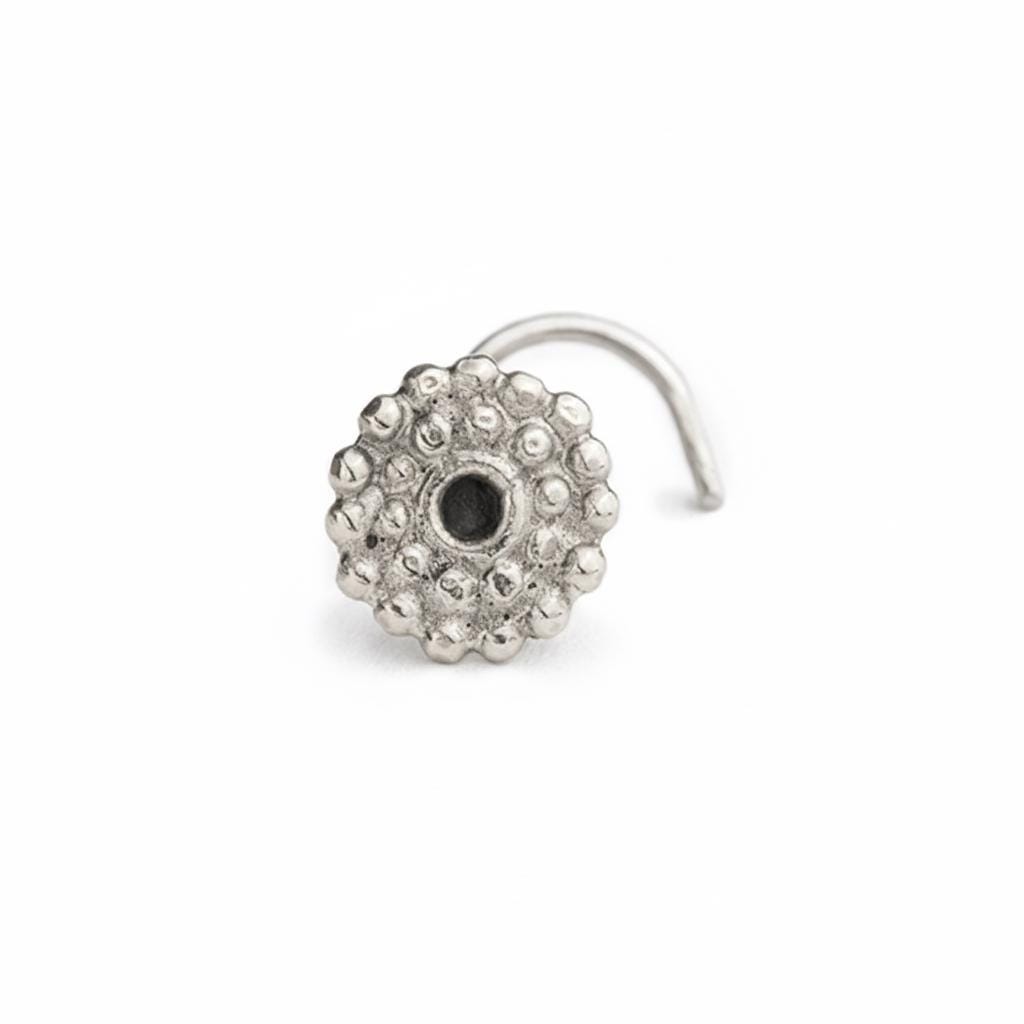 A silver-colored metal nose ring with a small black center hole.