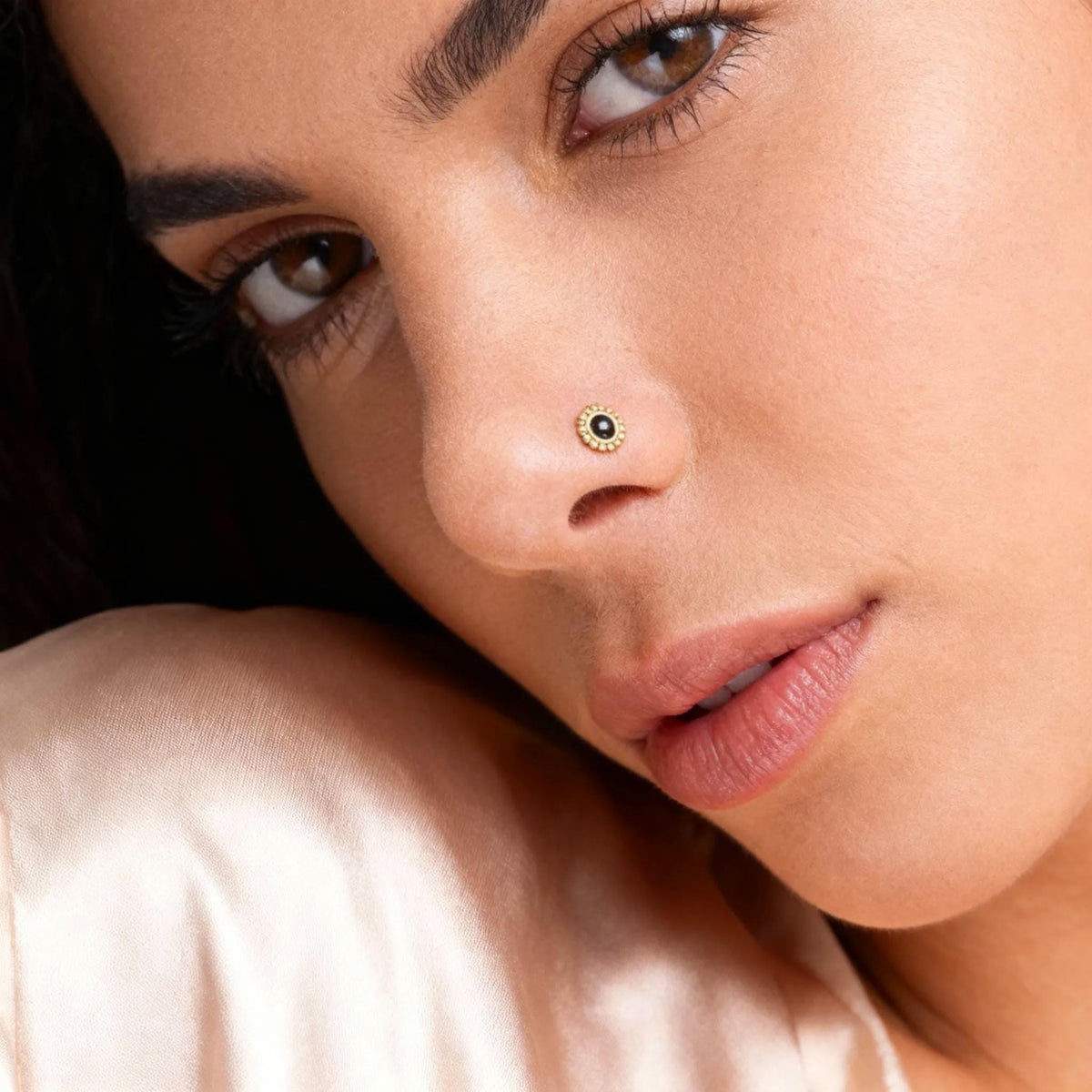 A close-up of a woman's face, focusing on her nose and chin.