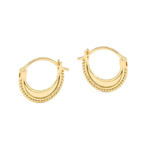 A pair of gold-colored earrings with a crescent moon design and small beads around the edges.
