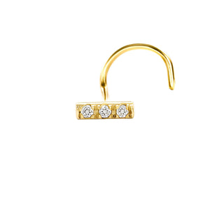 A gold nose ring with three diamonds set in a row.