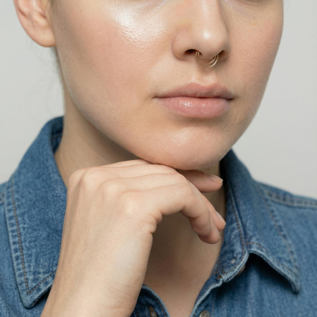 A close-up of a person's face, focusing on their hand and chin.