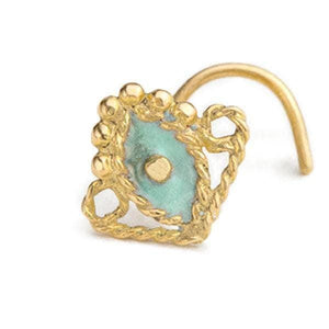A gold-colored nose ring with a turquoise stone in the center, surrounded by a decorative gold frame.