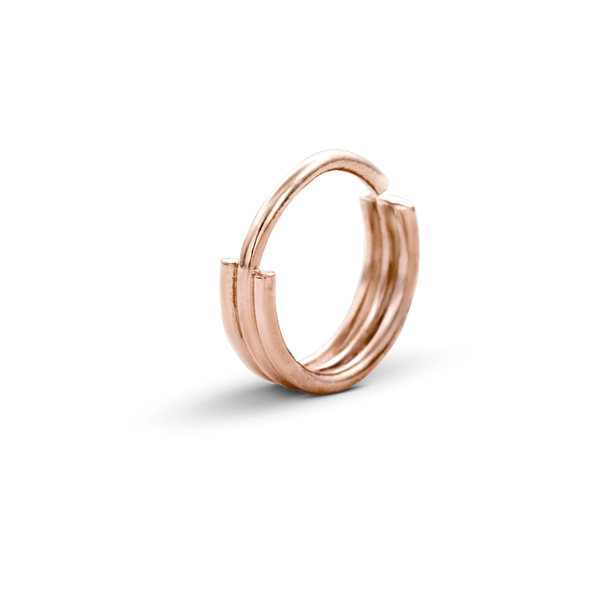 A single, shiny, copper-colored ring with a unique, twisted design.