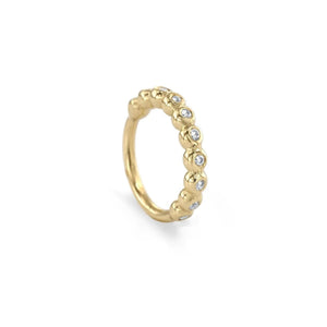 A gold ring with a row of small diamonds or gemstones set in the center.