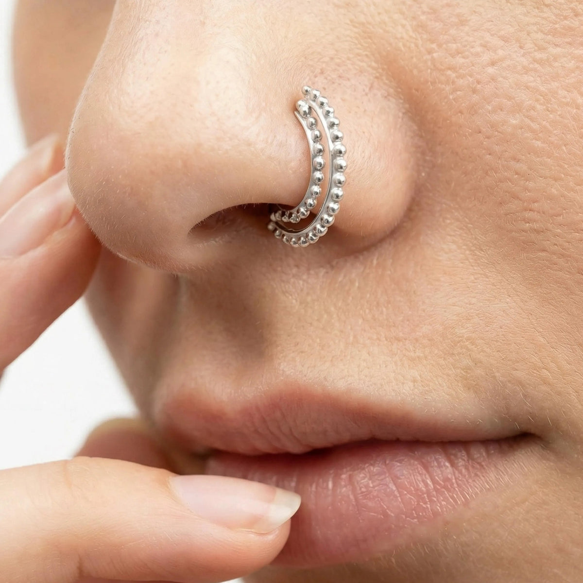 Indian Nose Hoop: A close-up of a person's face, focusing on their nose and lips.