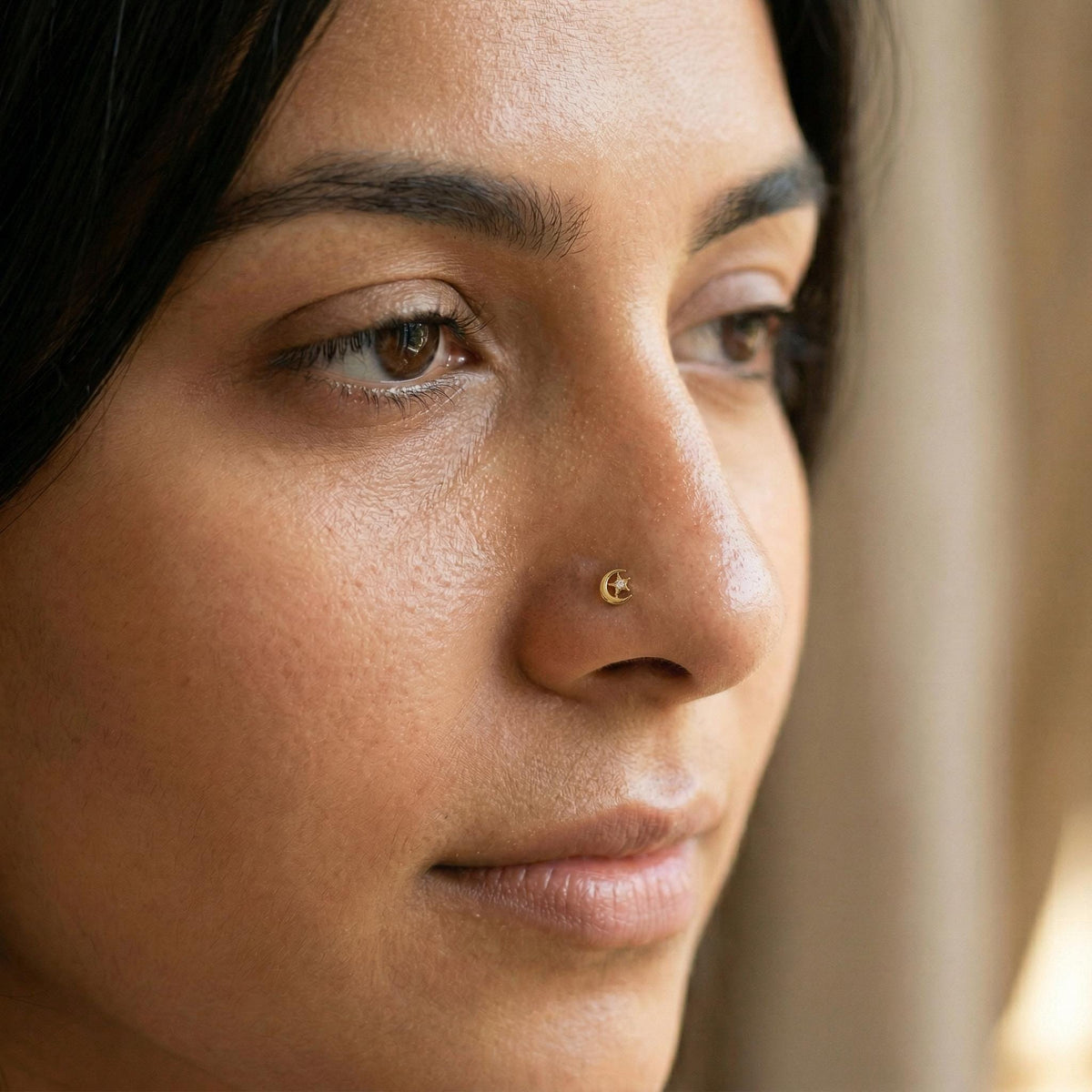 A close-up of a woman's face, focusing on her nose and the left side of her face.