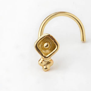 Small Indian Nose Pin: A gold-colored metal nose ring with a small, square-shaped charm attached to it.