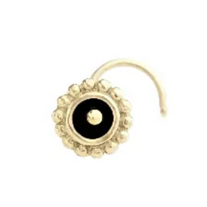 A gold-colored nose ring with a black center and a decorative pattern around it.