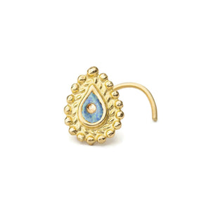 A gold-colored nose ring with a blue gemstone in the center, set against a white background.