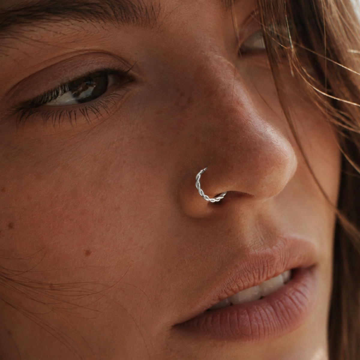 A close-up of a woman's face, focusing on her nose and eye.