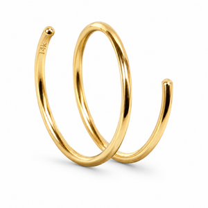A gold ring with a spiral design, featuring a small ball at the top.