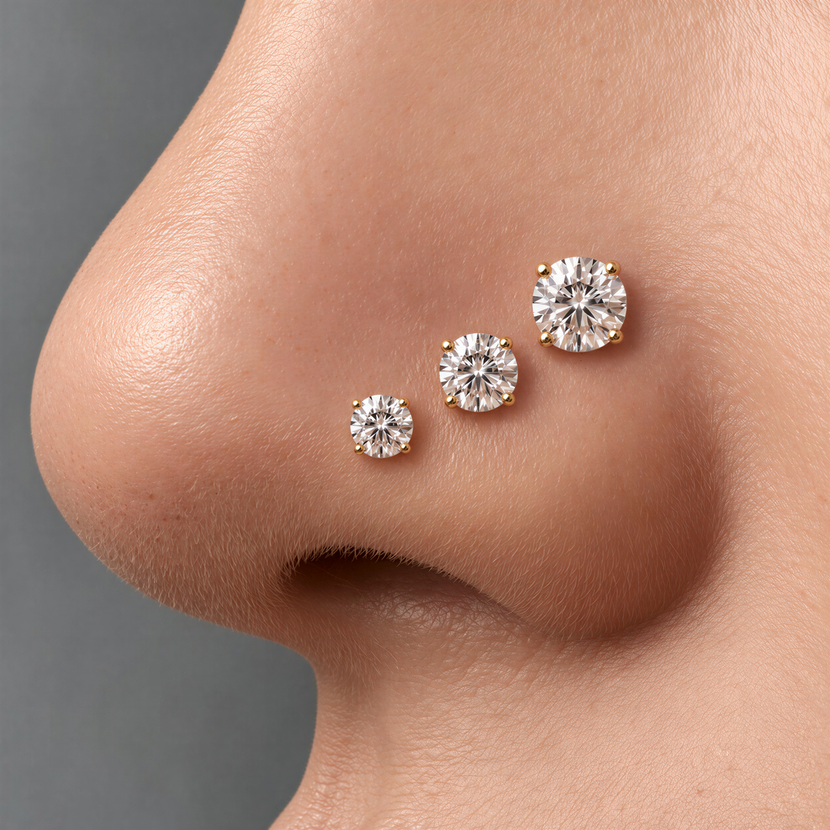 A close-up of a person's nose with three small diamonds on it.