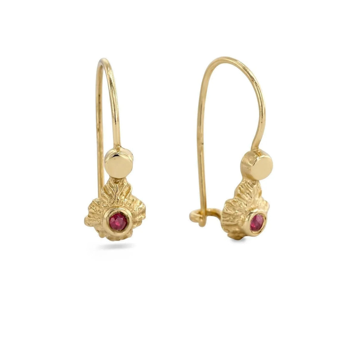 a pair of gold earrings with a red gemstone, possibly a ruby, set in the center.
