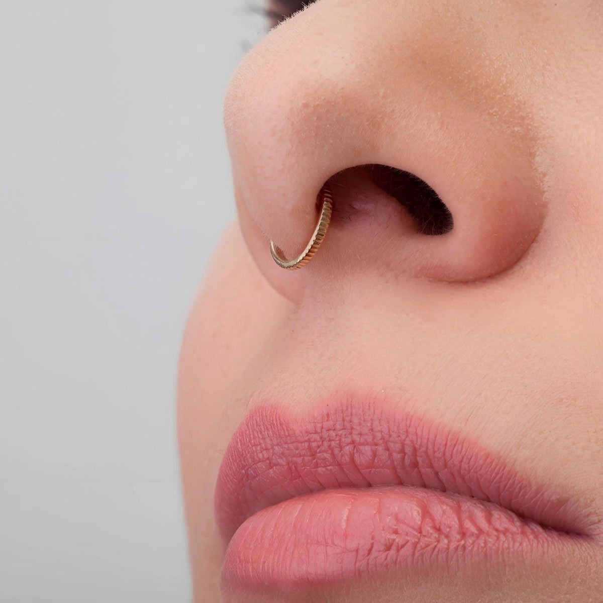 A close-up of a person's face, focusing on their nose and lips.