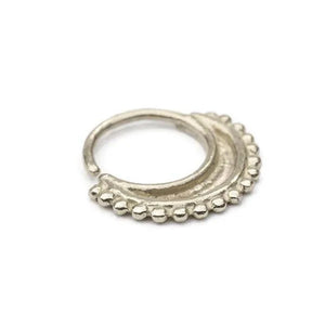 A silver-colored metal ring with a decorative element on the edge.