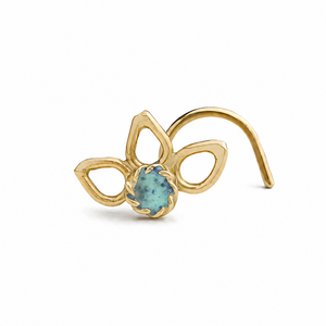 A gold-colored nose ring with a blue gemstone in the center.