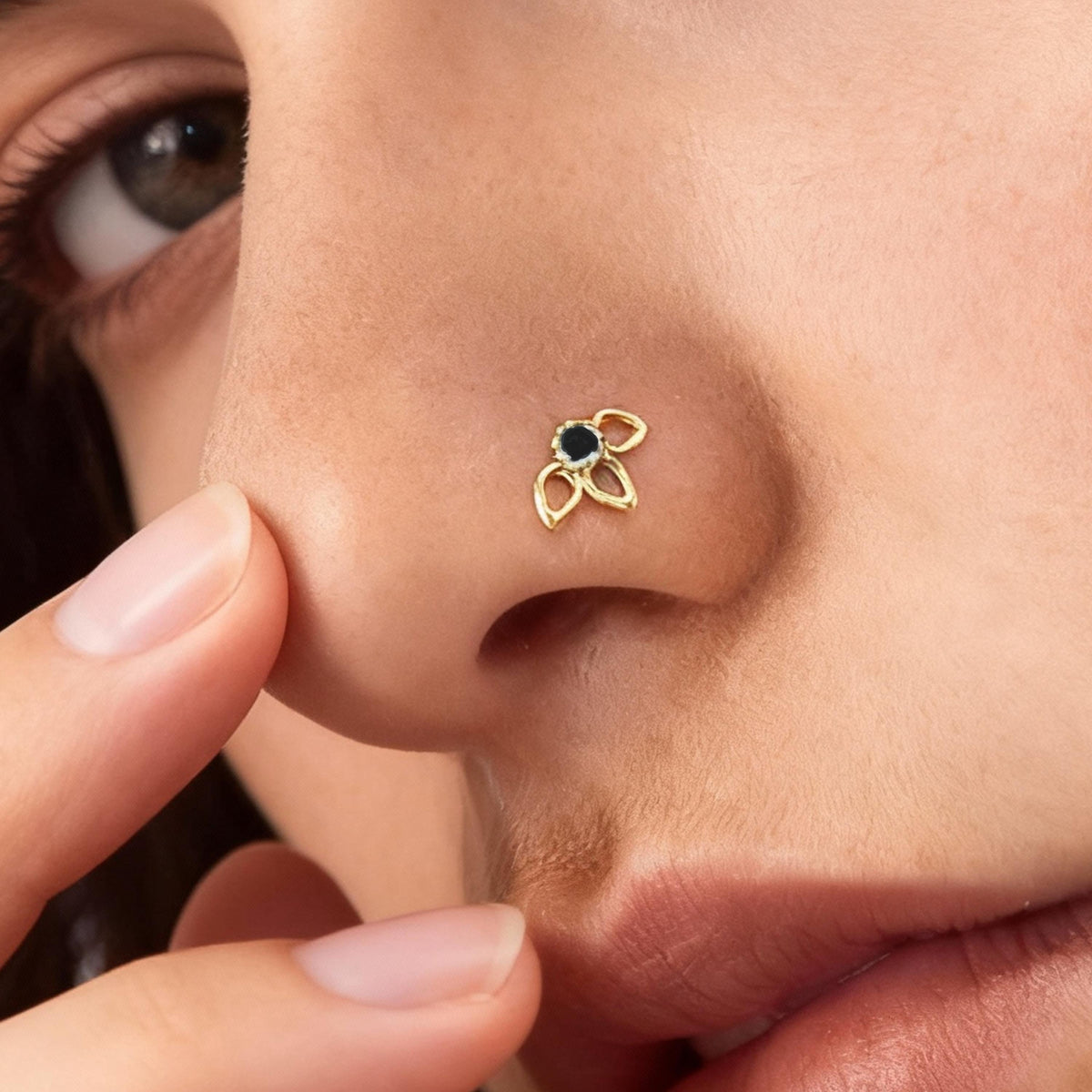 A close-up of a person's face, focusing on their nose and fingers.