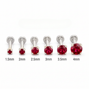 A collection of red gemstone-encrusted metal piercings, each with a different size ranging from 1.5mm to 4mm.
