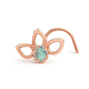 Nose Stud Jewelry: A single, ornate copper-colored nose ring with a green gemstone in the center.
