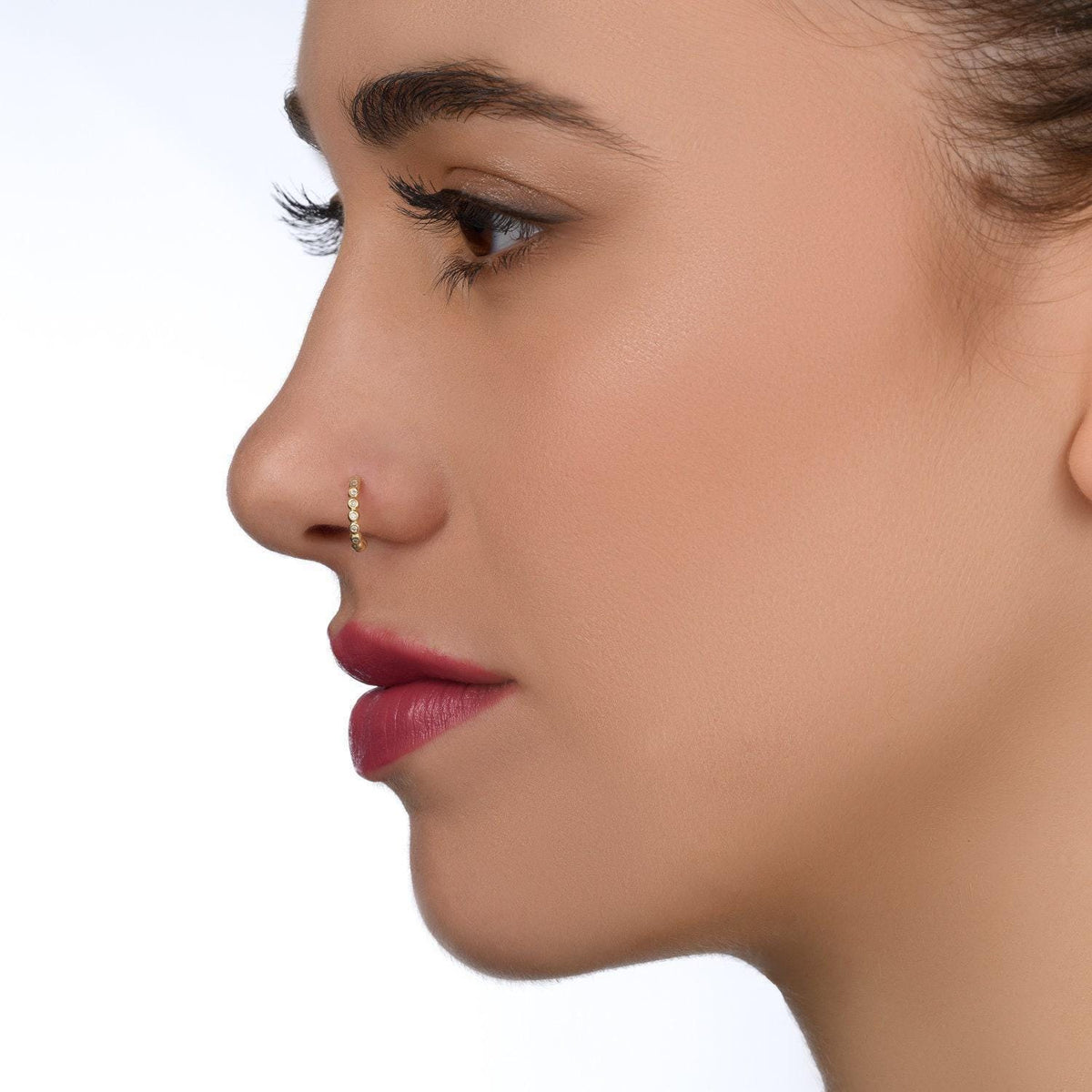 A close-up profile view of a woman's face, focusing on her nose and lips.