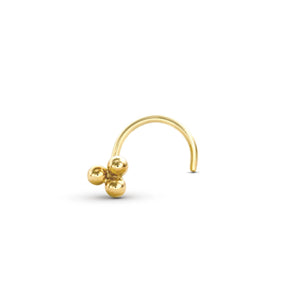 A gold-colored metal nose ring with three small balls on it.