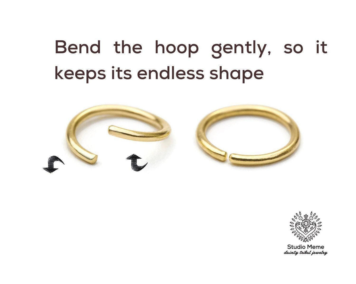 two gold hoop earrings, one bent gently and the other straight, demonstrating how to bend the hoop gently to maintain its shape.