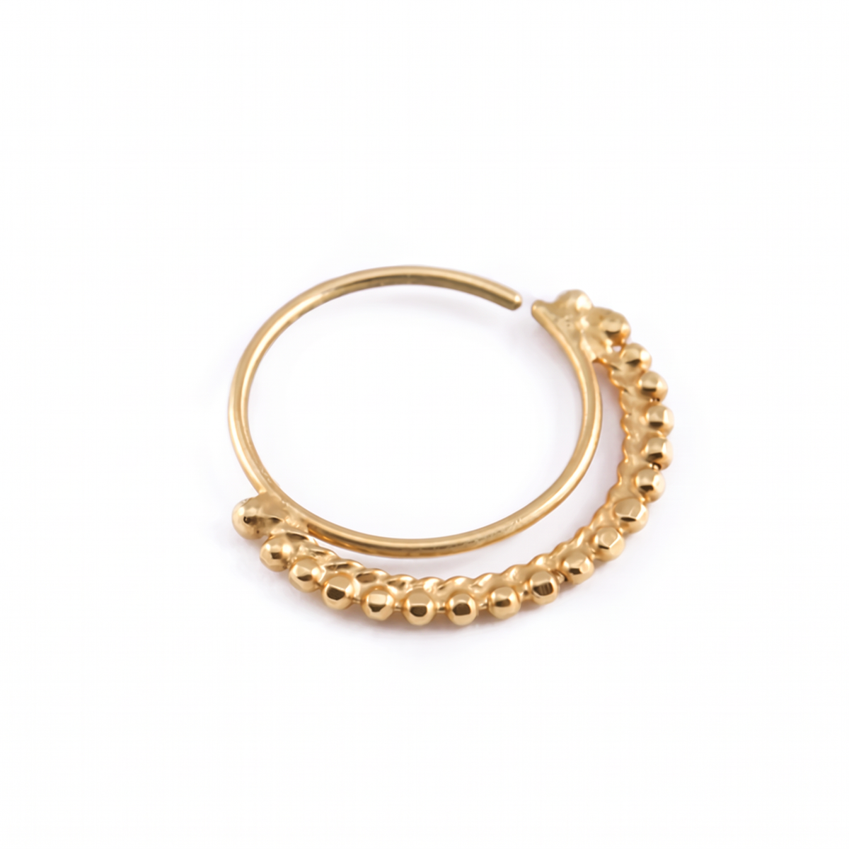 A gold-colored metal ring with a curved design and a row of small, round beads or stones attached to it.