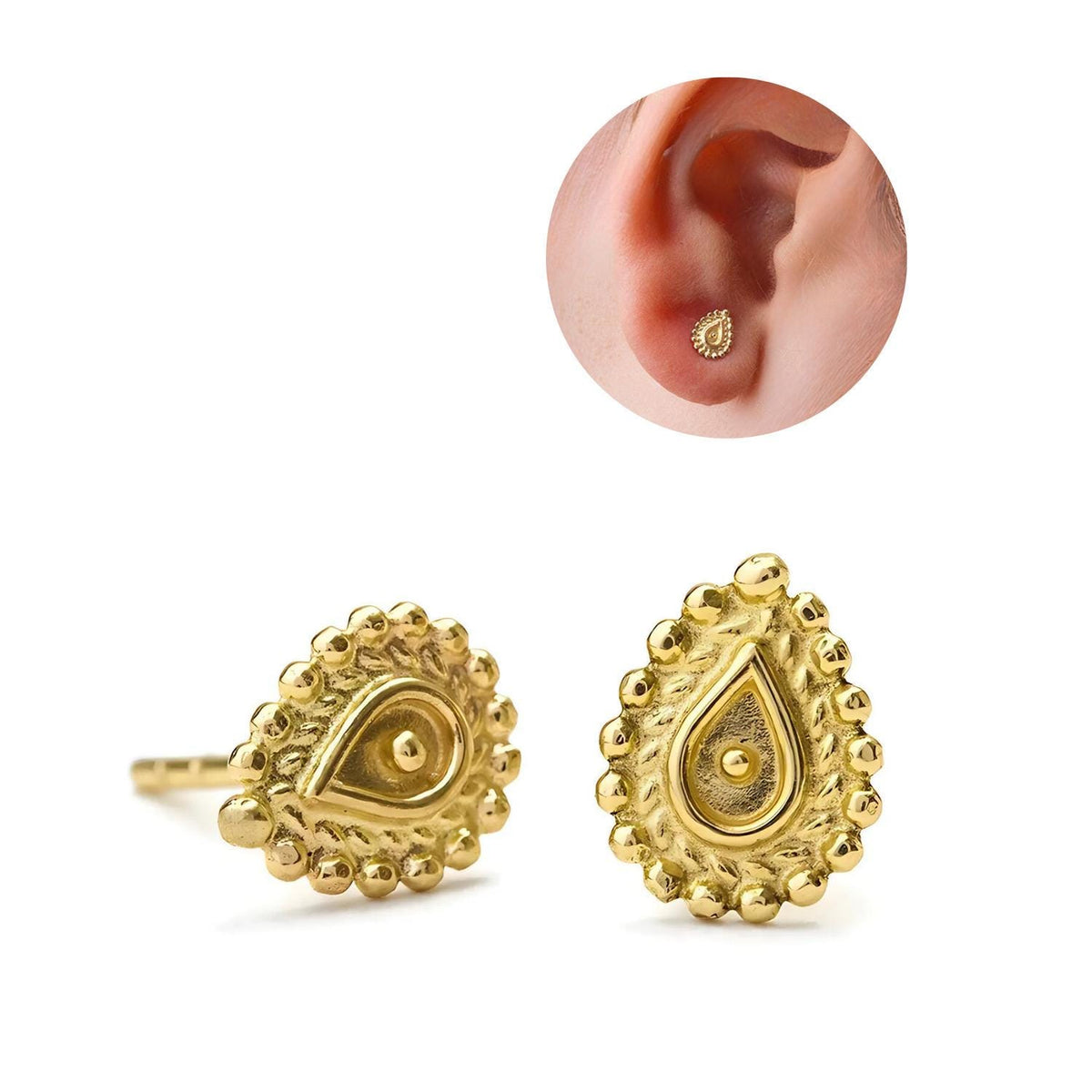 two gold earrings with intricate designs, including a teardrop-shaped earring and a small gold earring in the ear.