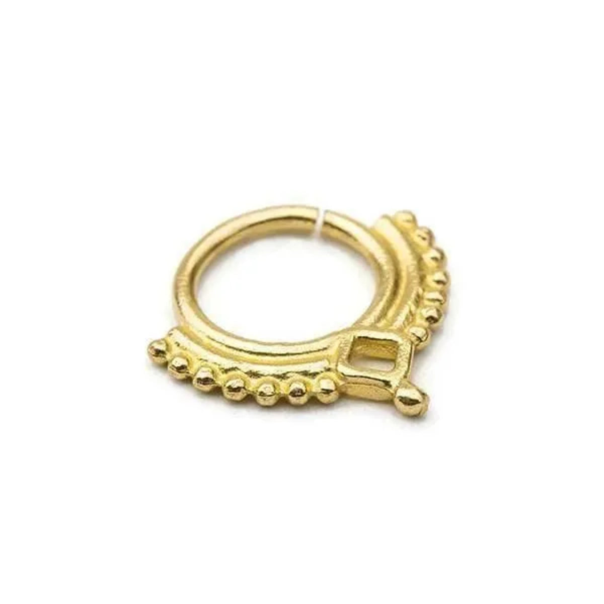 A gold-colored metal ring with a decorative design on the edges.