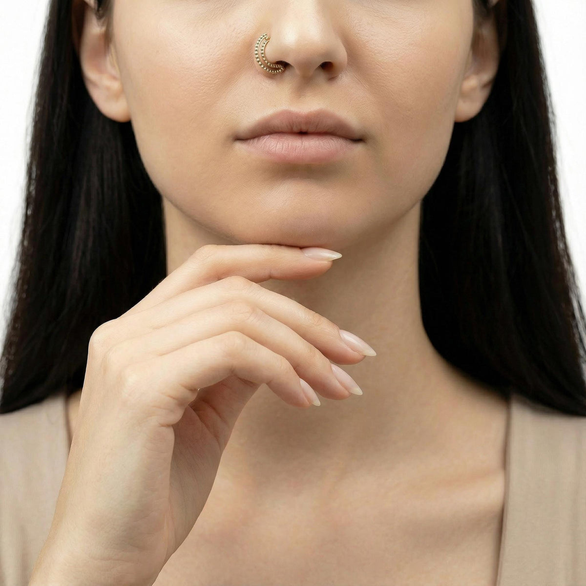 A close-up of a woman's face, focusing on her hand and nose.