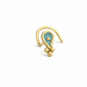 A gold-colored nose ring with a blue gemstone in the center.