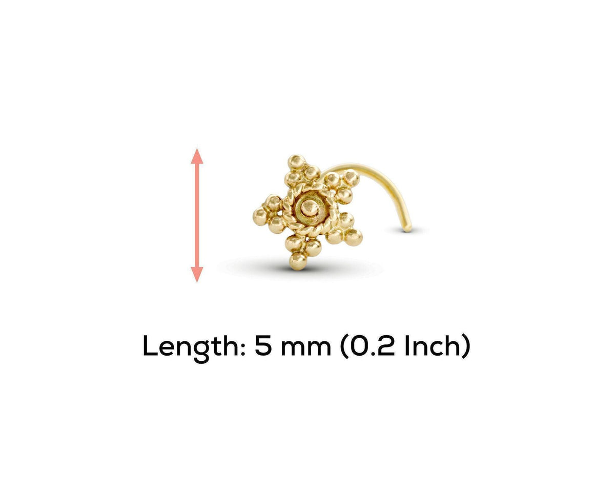 A silver-colored metal nose ring with a star-shaped design and small beads or stones.