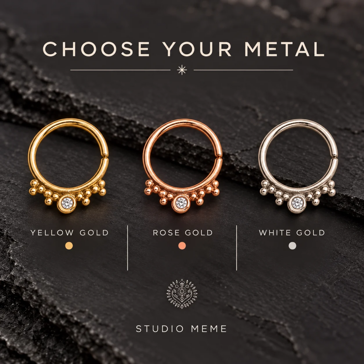 three rings with different colored gemstones, each labeled with the color of the metal used: yellow gold, rose gold, and white gold.