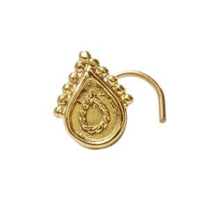 a gold nose ring with a decorative design on the front.