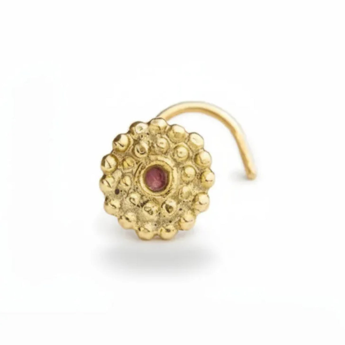 A gold-colored nose ring with a red gemstone is shown against a white background.