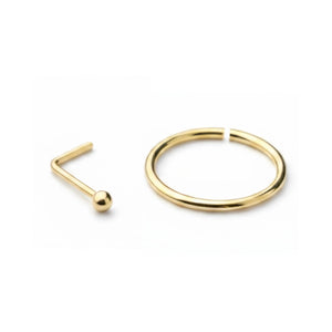 a gold-colored nose ring and a gold-colored ring on a white background.