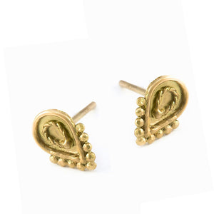 A pair of gold earrings with a decorative design on the front.