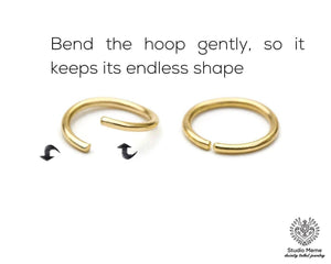two gold hoop earrings, one bent gently and the other straight, demonstrating how to bend the hoop to maintain its shape.
