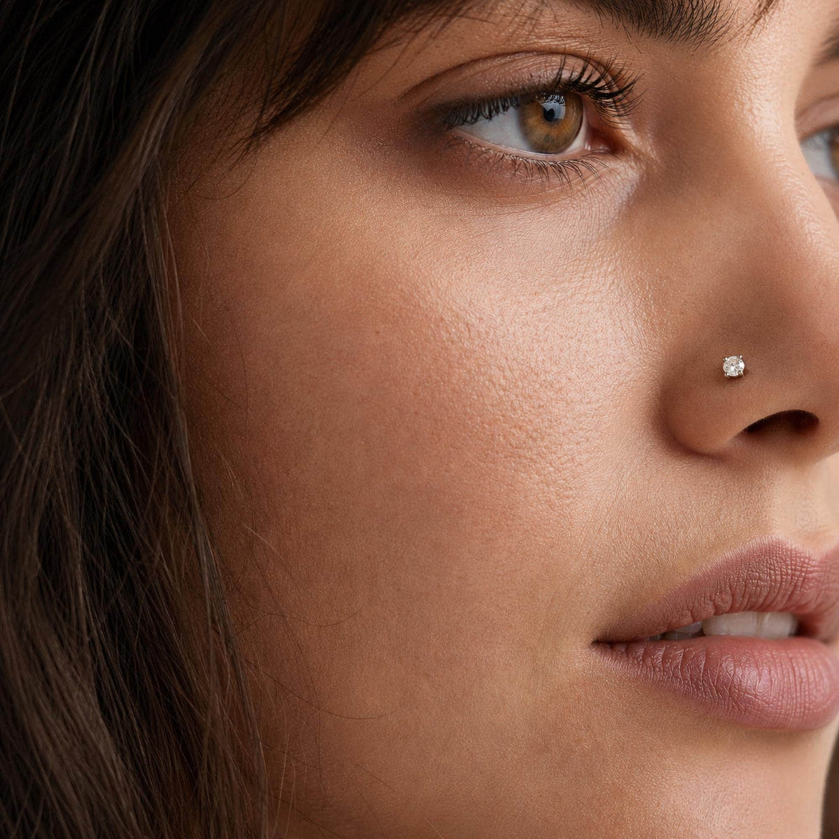 A close-up of a woman's face, focusing on her nose and surrounding skin.