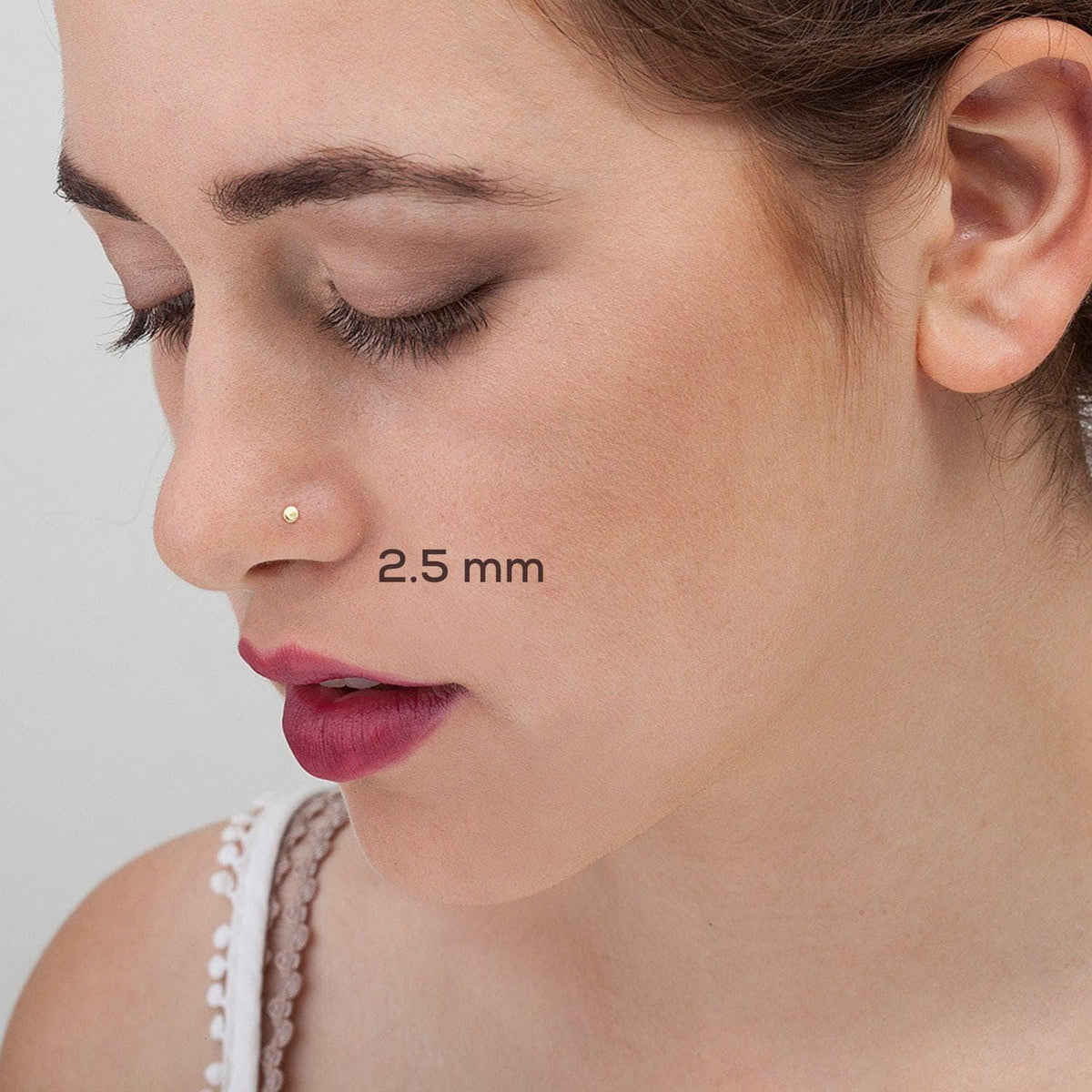 A close-up of a woman's face, focusing on her nose and cheek area.